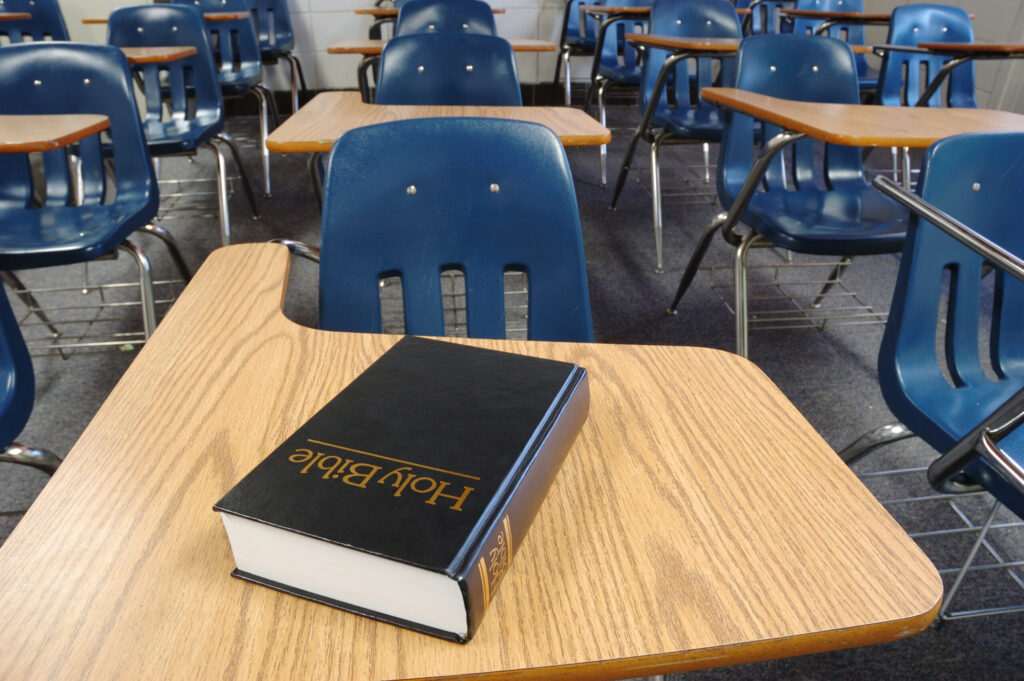 Kansas school principal who helped hand out Bibles to students violated