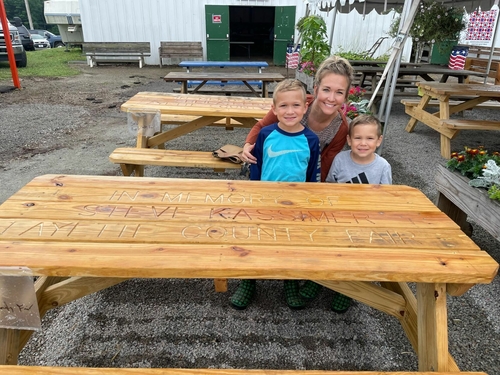 World of Good Foundation carries out SWPA man’s ‘legacy of kindness’ | Helping the Helpers Steve Kassimer's sons, Cohen (left) and Wyatt (right) sit with their mom Kristi Kassimer Harper at a picnic table at the Fayette County Fair. The boys lost their father in 2020, but continue to mirror his sense of kindness through the World of Good Foundation.