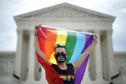 Could Milwaukee County become a sanctuary for LGBTQ people? WASHINGTON, DC - JUNE 15: Joseph Fons holding a Pride Flag, stands in front of the U.S. Supreme Court building after the court ruled that LGBTQ people can not be disciplined or fired based on their sexual orientation June 15, 2020 in Washington, DC. With Chief Justice John Roberts and Justice Neil Gorsuch joining the Democratic appointees, the court ruled 6-3 that the Civil Rights Act of 1964 bans bias based on sexual orientation or gender identity. (Photo by Chip Somodevilla/Getty Images)