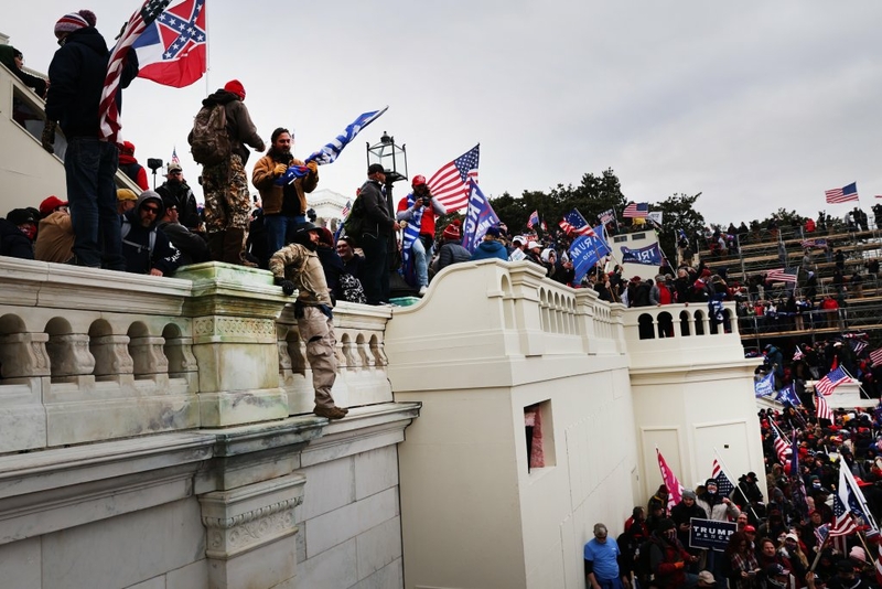Thousands of Donald Trump's supporters storm the U.S. Capitol building following a "Stop the Steal" rally on Jan. 6, 2021 in Washington, D.C. The protesters stormed the historic building, breaking windows and clashing with police. Trump supporters had gathered in the nation's capital to protest the ratification of Joe Biden's Electoral College victory over Trump in the 2020 election. (Photo by Spencer Platt/Getty Images)