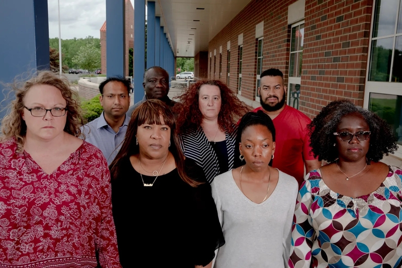 Parents and leaders stand at the Suffield High School. About 40 parents and residents created a group and meet once a week to discuss goals and actions plans to create policy changes to help eradicate racism in the school system. YEHYUN KIM / CTMIRROR.ORG