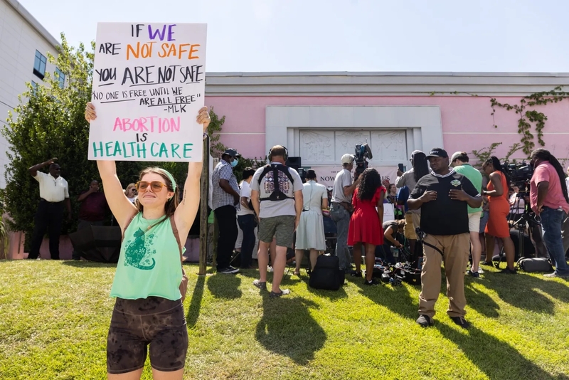 A pro-choice activist holds a sign outside of the Jackson Women's Health Organization in Jackson, Miss., Friday, June 24, 2022. The Supreme Court overturned Roe vs. Wade, the 1973 case that established a person’s right to an abortion. Credit: Eric Shelton/Mississippi Today