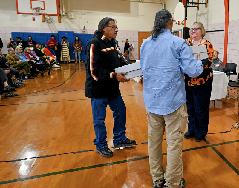 Burn, bury or display: Tribal nations discuss how to treat stolen items from Wounded Knee victims Ann Meilus, president of the Barre Museum Association, hands a symbolic box to Cedric Broken Nose, left, and Michael He Crow during a November 2022 ceremony in Barre, Massachusetts, to commemorate the return of remains and artifacts stolen from the site of the Wounded Knee massacre to the Sioux tribes. (Allan Jung, Telegram & Gazette)