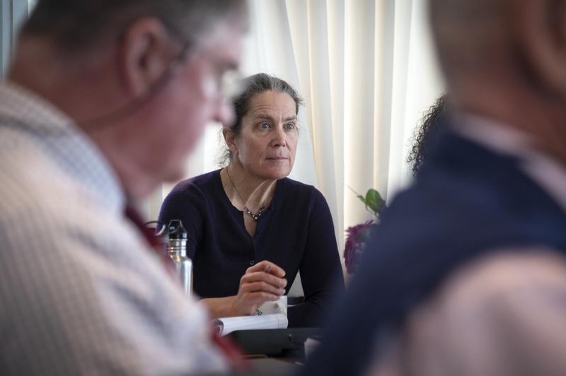 Wild divide: A debate over wildlife management in Vermont runs deep A woman sitting at a table in front of a group of people.