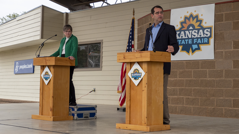 Kansas doesnât have a brand while New York does? Fuhgeddaboudit! Kansas Gov. Laura Kelly and her challenger, Attorney General Derek Schmidt, debate Sept. 10, 2022, at the Kansas State Fair in Hutchinson. (Sherman Smith/Kansas Reflector)