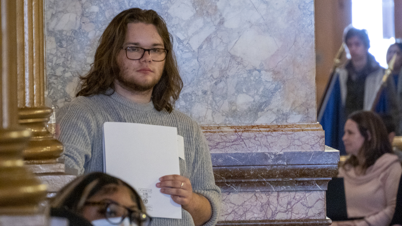 Statehouse scraps: Catholic lobby’s stance on abuse bill, Medicaid losses, fentanyl frustration Adam Kellog, a transgender man and University of Kansas student from Olathe, listens to speakers during a bodily autonomy rally March 6, 2023, at the Statehouse in Topeka